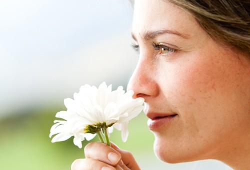 woman smelling a flower